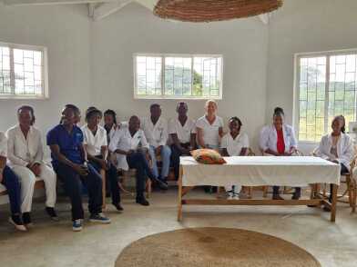 Rahel and the team of around 20 people sit in a semicircle