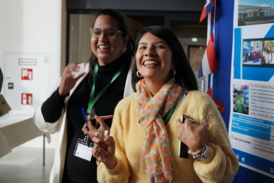 Two ladies are looking happy and animated.