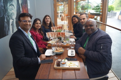 A group of people is sitting at a table with Austrian food.